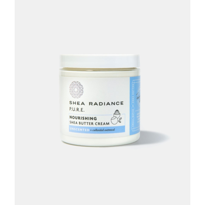 A white and blue jar of shea radiance pure nourishing shea butter cream. Unscented with colloidal oatmeal. 
